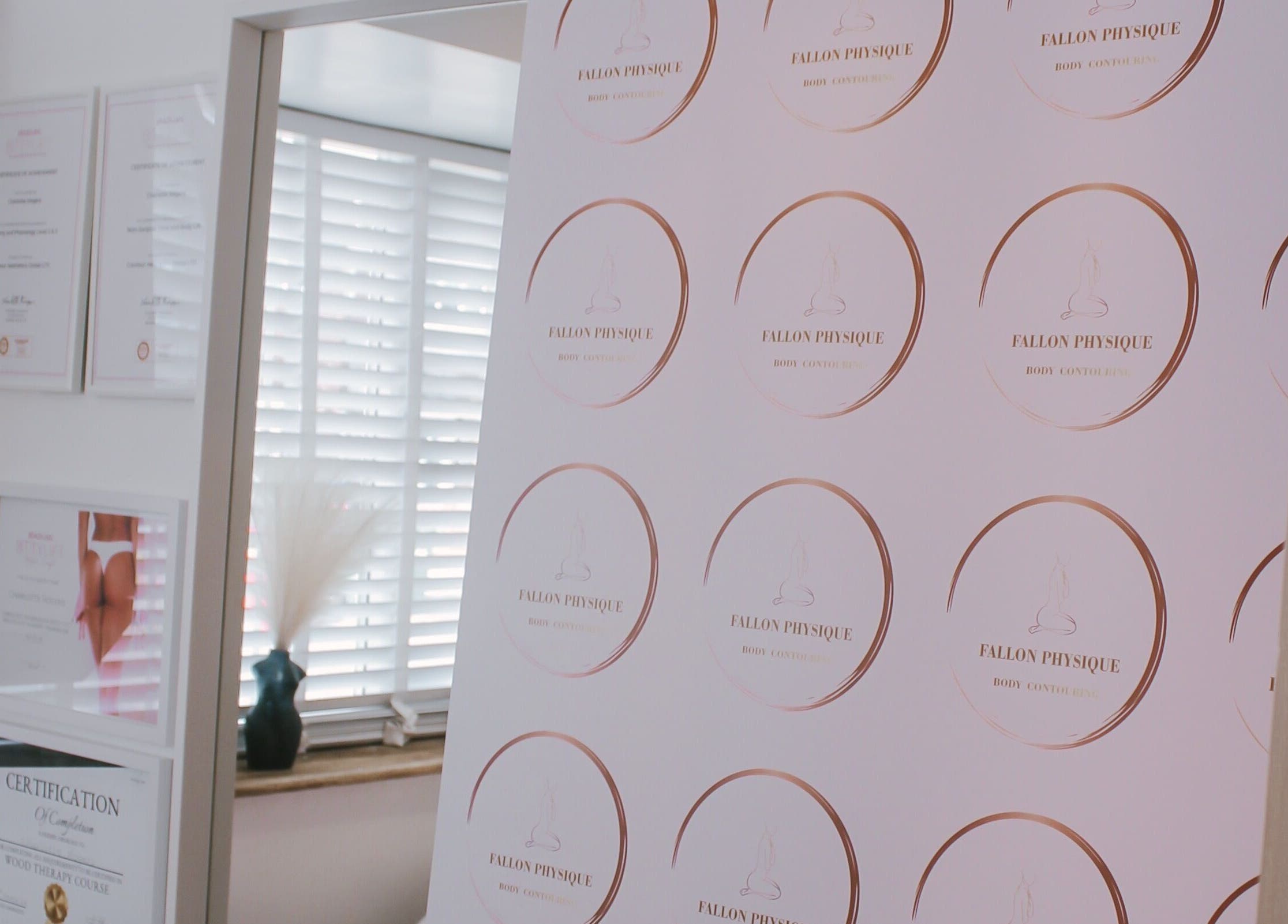 Fallon Physique certificates displayed elegantly in Bordon, England, GB wellness center.