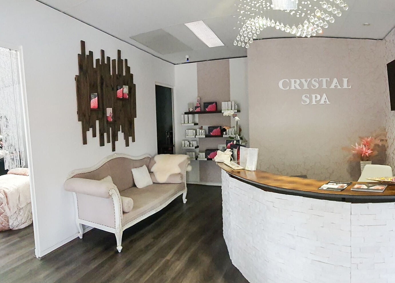 Inviting reception area at Crystal Spa in Perth, Western Australia, AU, featuring a cozy sofa and elegant decor.