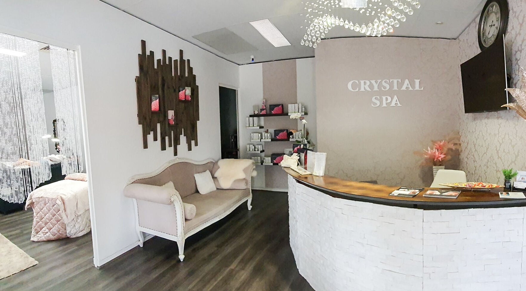 Inviting reception area at Crystal Spa in Perth, Western Australia, AU, featuring a cozy sofa and elegant decor.