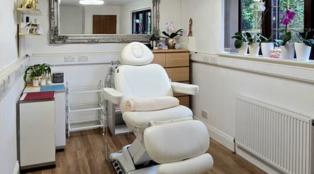 Luxurious treatment room at Amber Beauties, Goffs Oak, England, GB with plush chair and elegant decor.