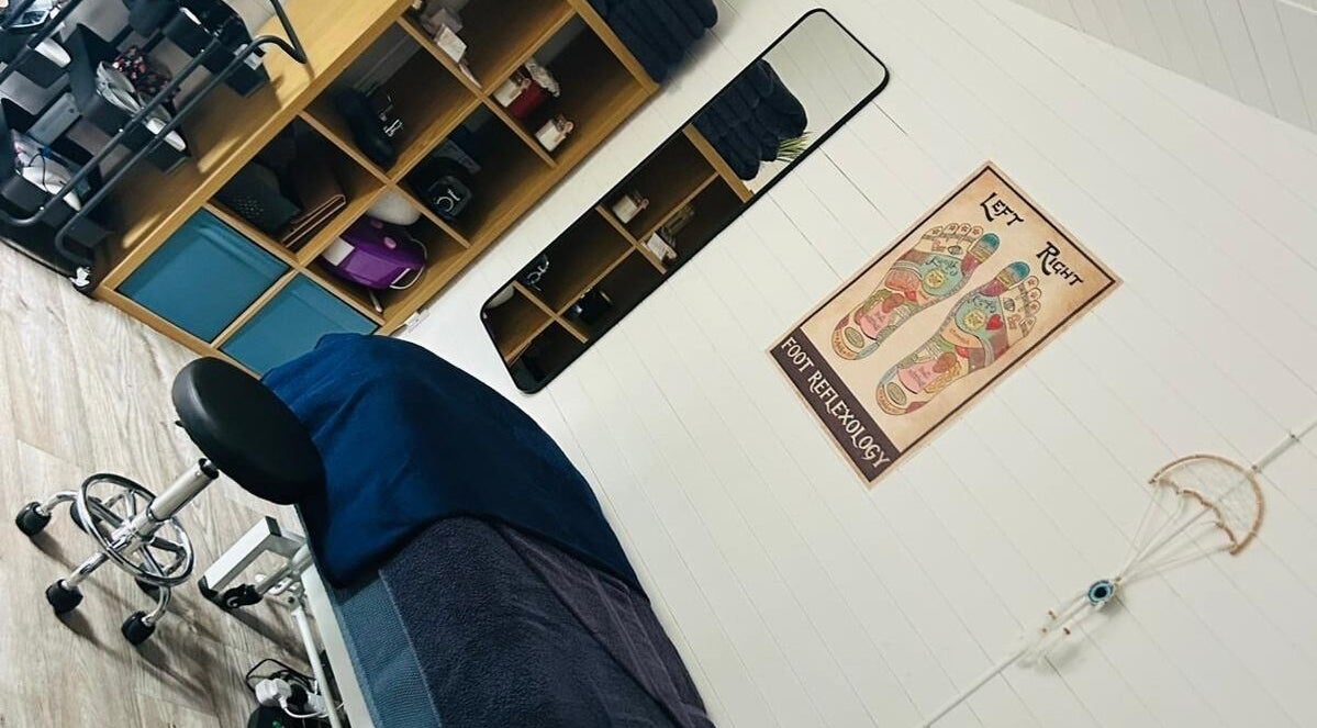 Relaxing therapy room at Blissful Touch, Bugle, England, GB, showcasing a cozy massage bed and calming decor.