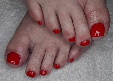 Red polished toes at Blissful Touch, Bugle, England, GB.