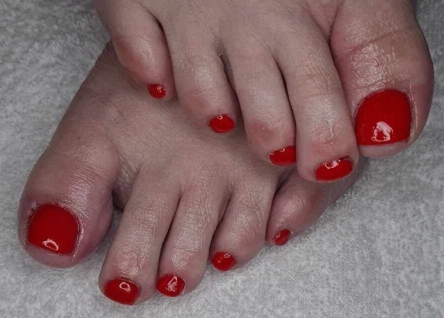 Red polished toes at Blissful Touch, Bugle, England, GB.