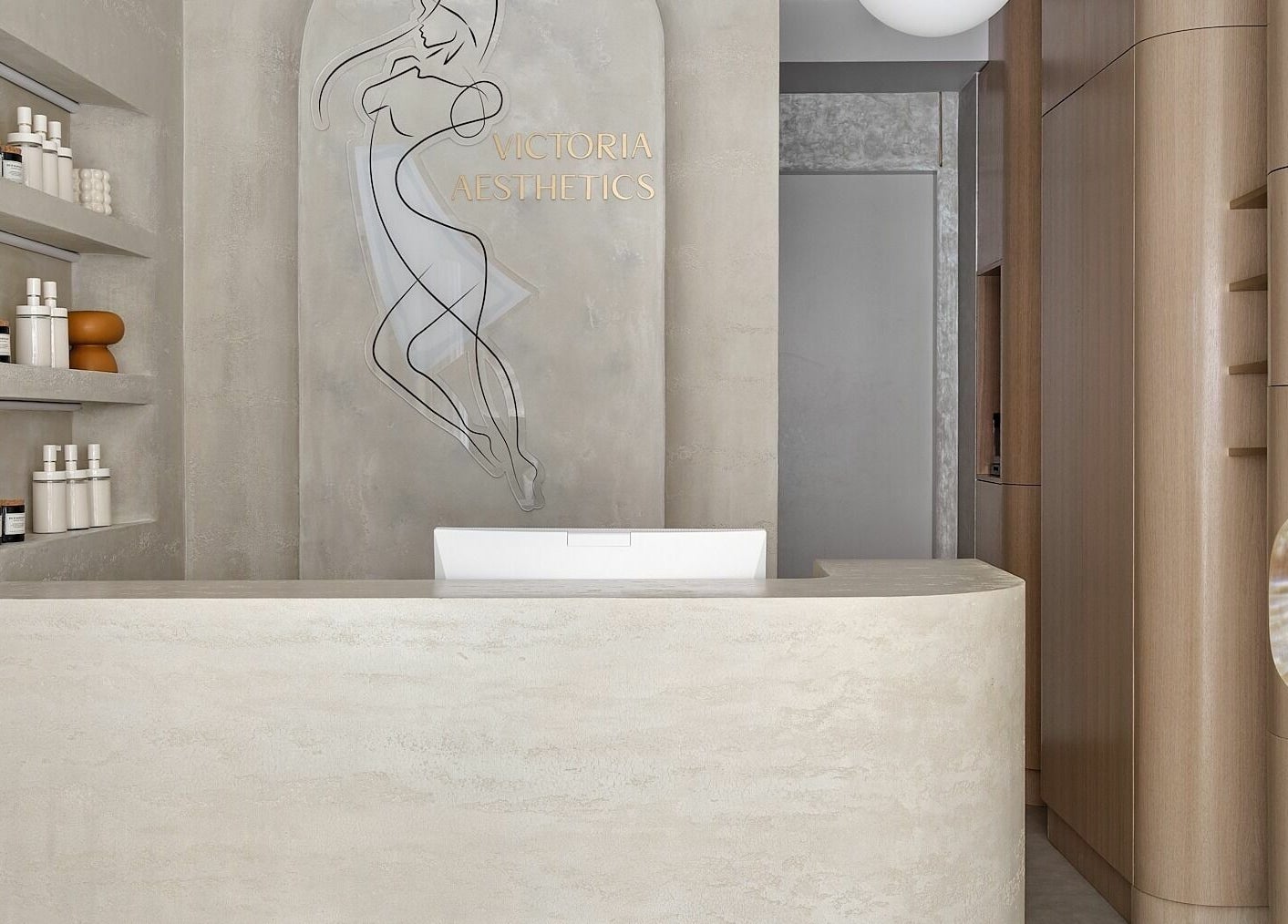Reception area of Victoria Aesthetics, London, England, featuring minimalist design and beauty products display.