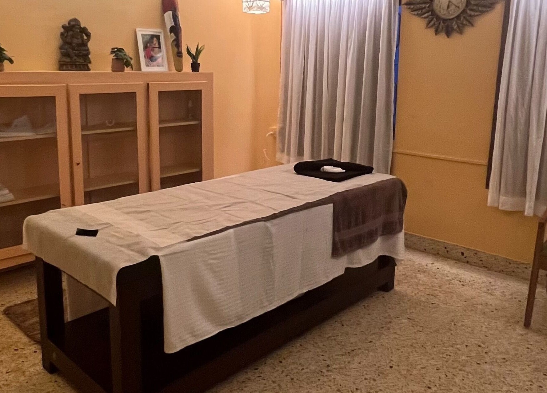 Cozy massage room at Praana Ayur Spa by Sarwaa in Varkala, Kerala, IN with a prepared treatment bed.