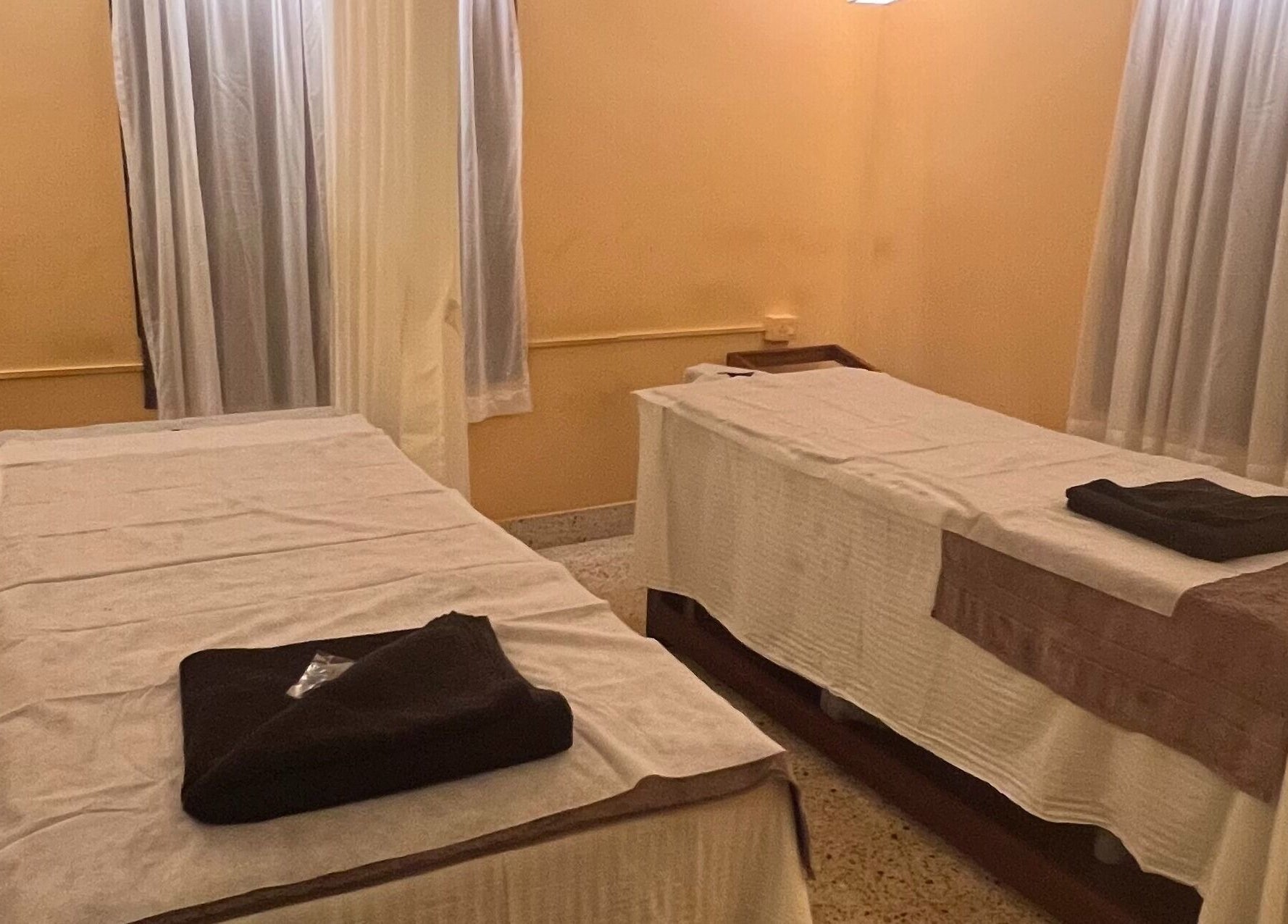 Tranquil massage room at Praana Ayur Spa by Sarwaa, Varkala, Kerala, IN, with two massage tables.