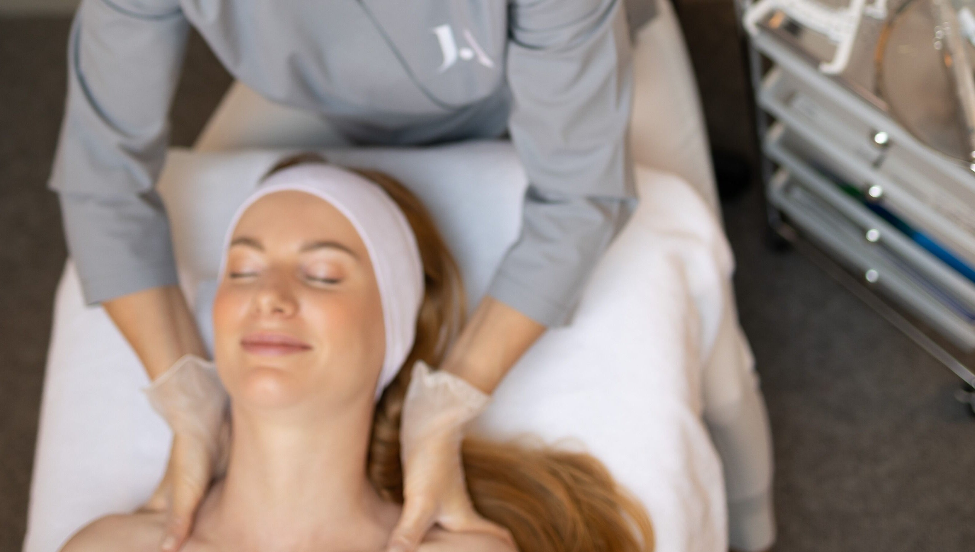 Client enjoying a soothing facial massage at Fitzrovia Aesthetics, London, England, GB.