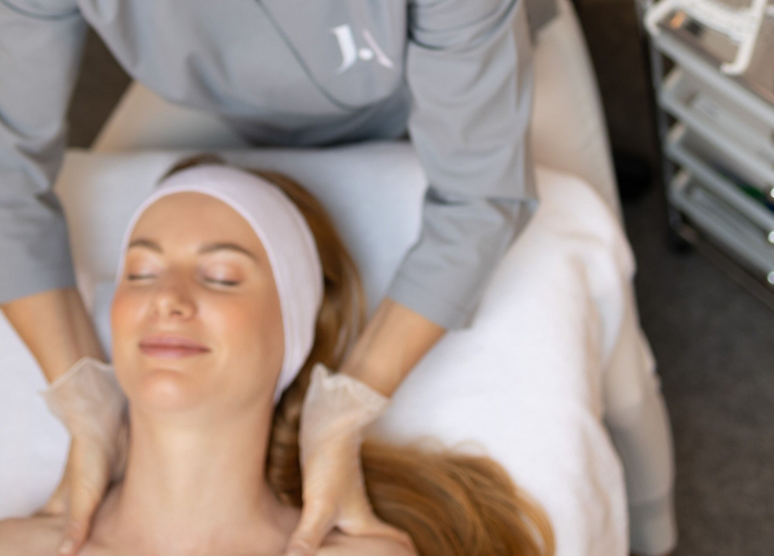 Client enjoying a soothing facial massage at Fitzrovia Aesthetics, London, England, GB.