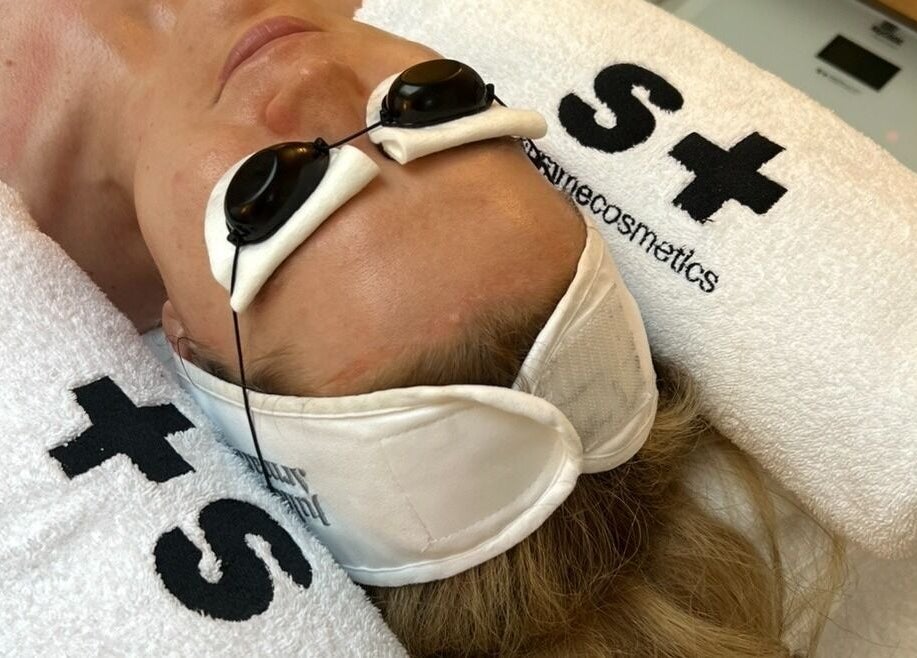 Client receiving a soothing facial treatment at Fitzrovia Aesthetics, London, England, GB.