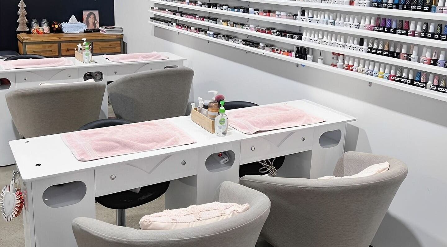 Coco Nails and Beauty nail stations in Auckland, Auckland, NZ featuring organized polish displays and cozy seating.