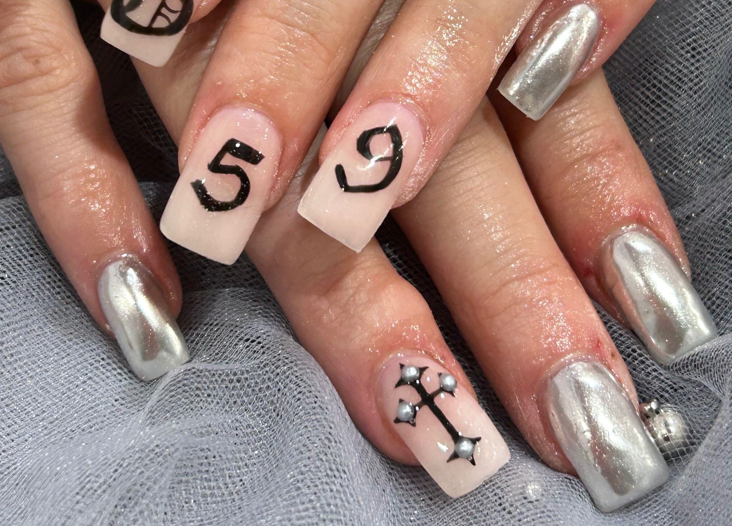 Stylish nail art at Coco Nails and Beauty in Auckland, Auckland, NZ with silver and unique designs.