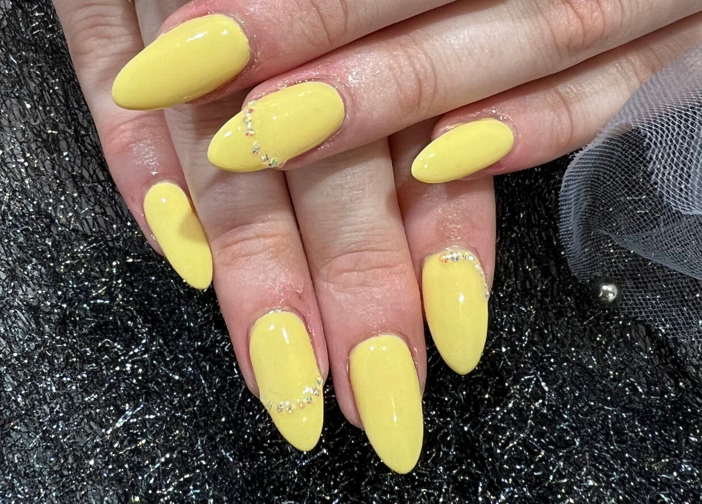 Yellow manicured nails with rhinestones at Coco Nails and Beauty, Auckland, Auckland, NZ.
