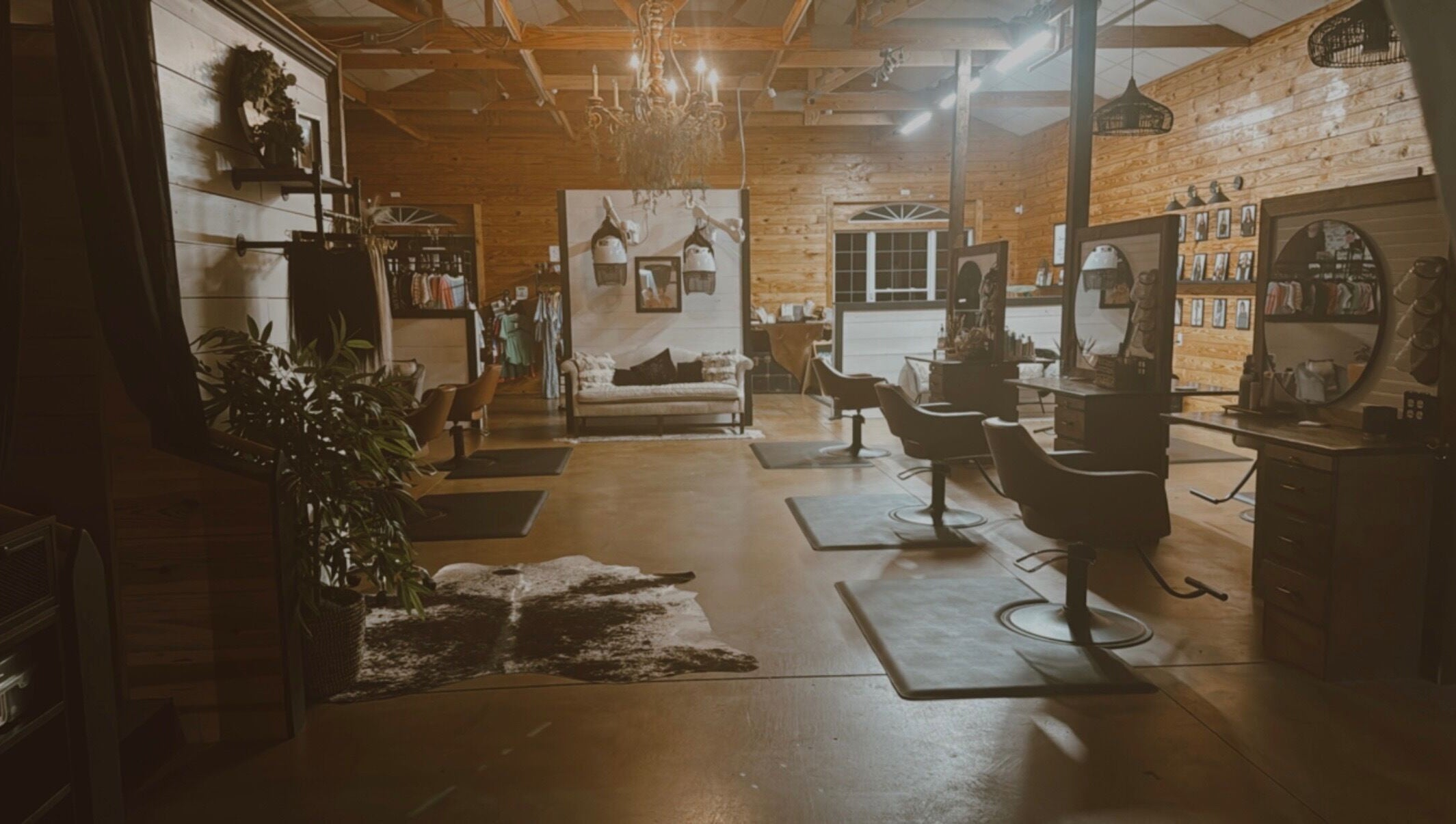 Interior of Meraki and Co Salon LLC in Greer, South Carolina, US, featuring elegant styling chairs and warm wooden decor.