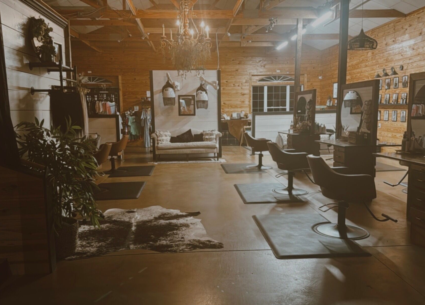 Interior of Meraki and Co Salon LLC in Greer, South Carolina, US, featuring elegant styling chairs and warm wooden decor.