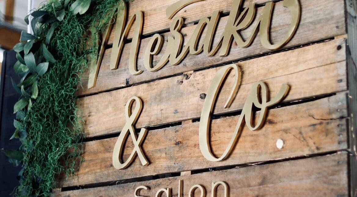 Wooden sign with elegant script for Meraki and Co Salon LLC in Greer, South Carolina, US.