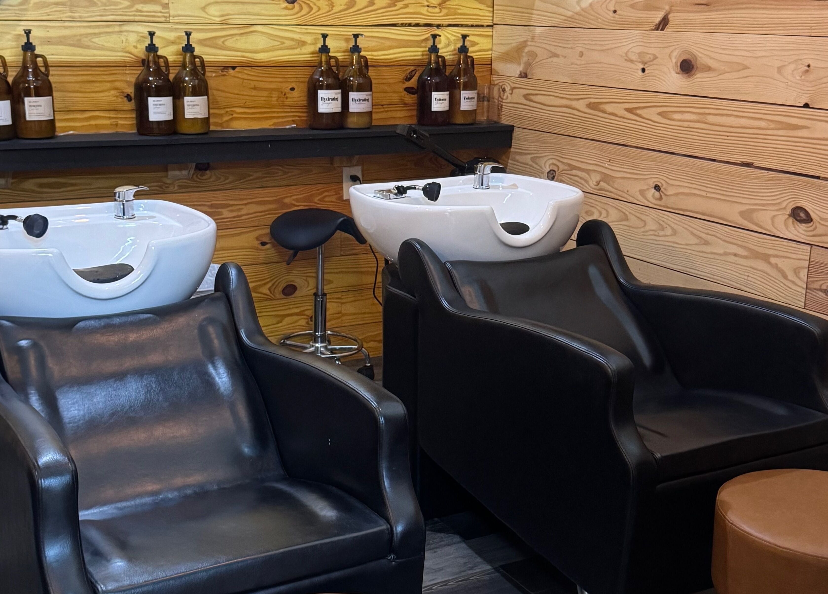 Luxurious wash station at Meraki and Co Salon LLC, Greer, South Carolina, US, featuring elegant leather chairs.