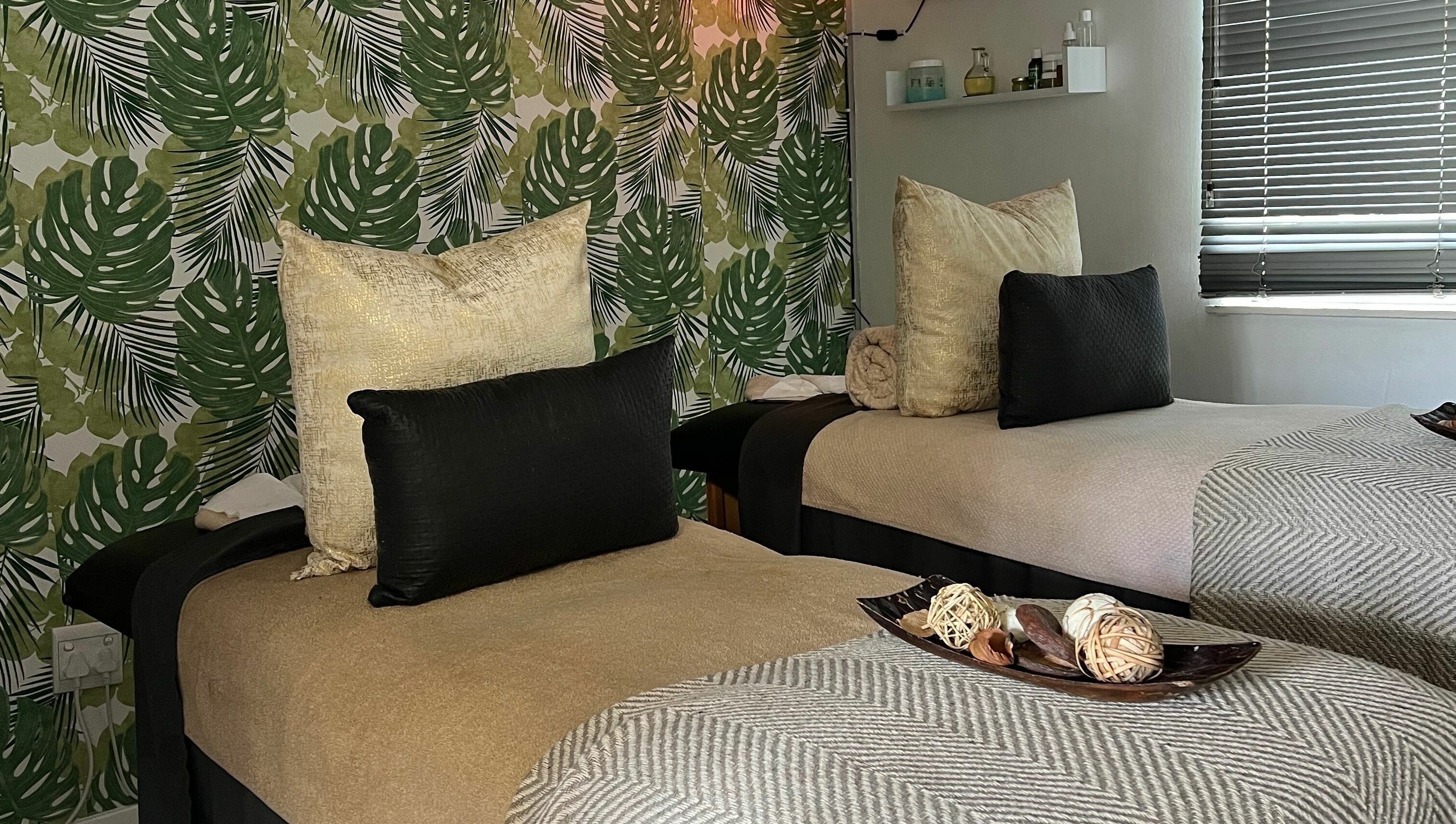 Relaxing therapy room with two beds at Snes Wellness Space, Sandton, Gauteng, ZA. Green leafy decor.