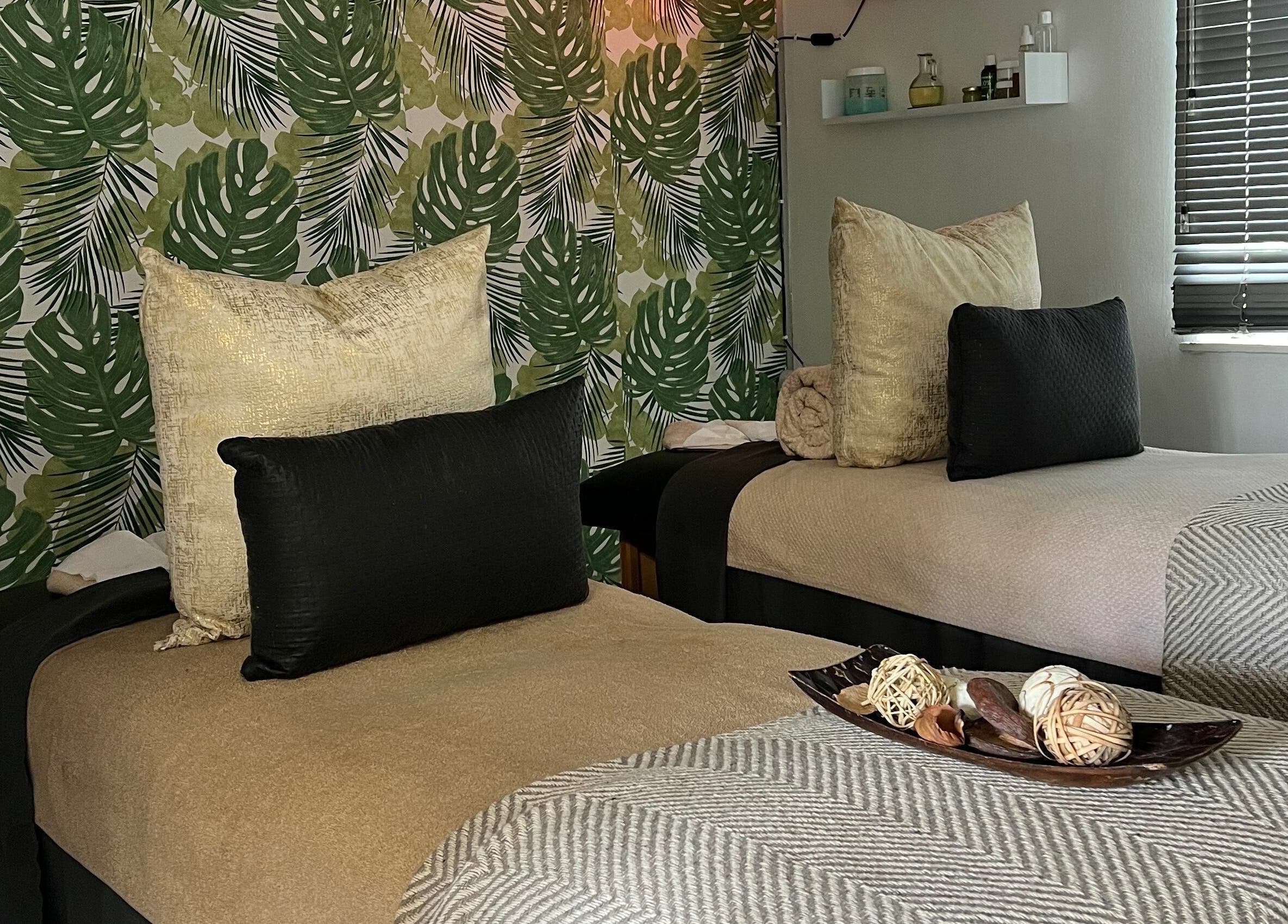 Relaxing therapy room with two beds at Snes Wellness Space, Sandton, Gauteng, ZA. Green leafy decor.