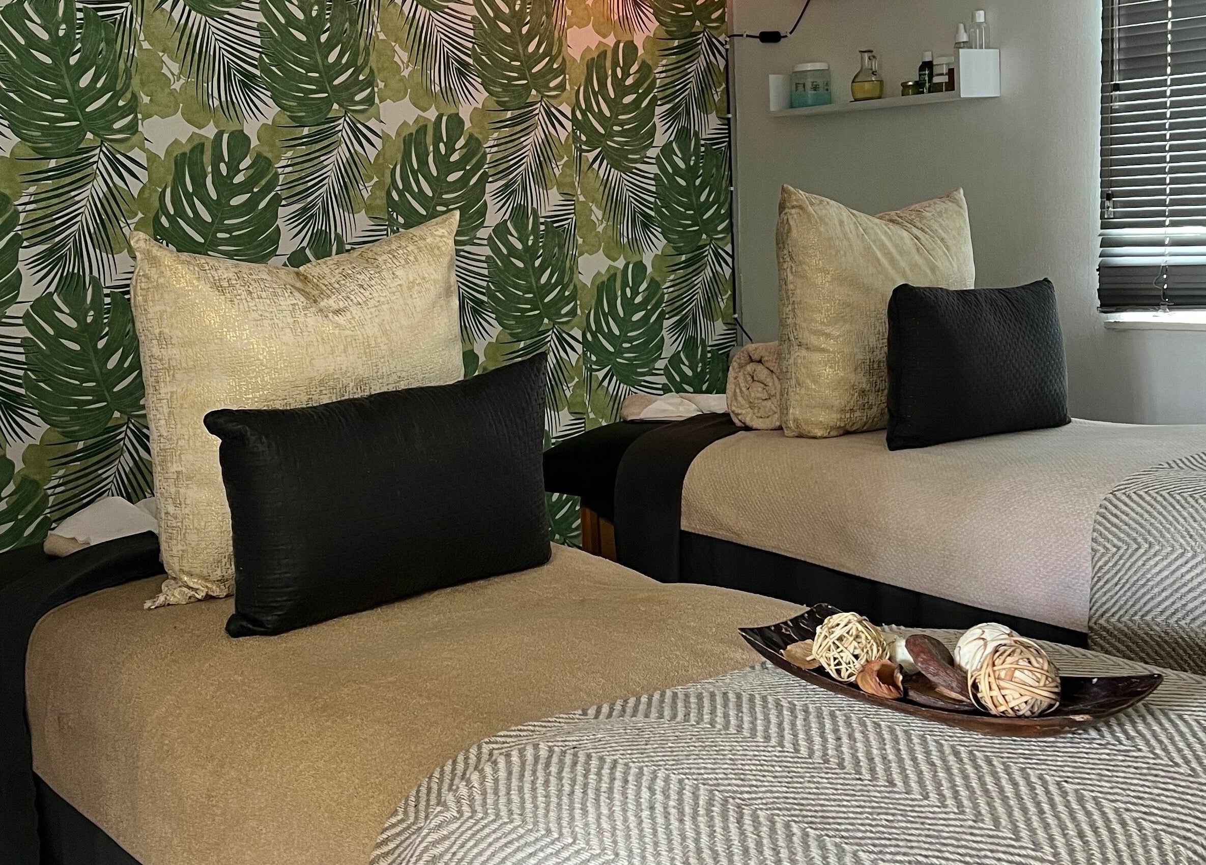 Relaxing therapy room with two beds at Snes Wellness Space, Sandton, Gauteng, ZA. Green leafy decor.