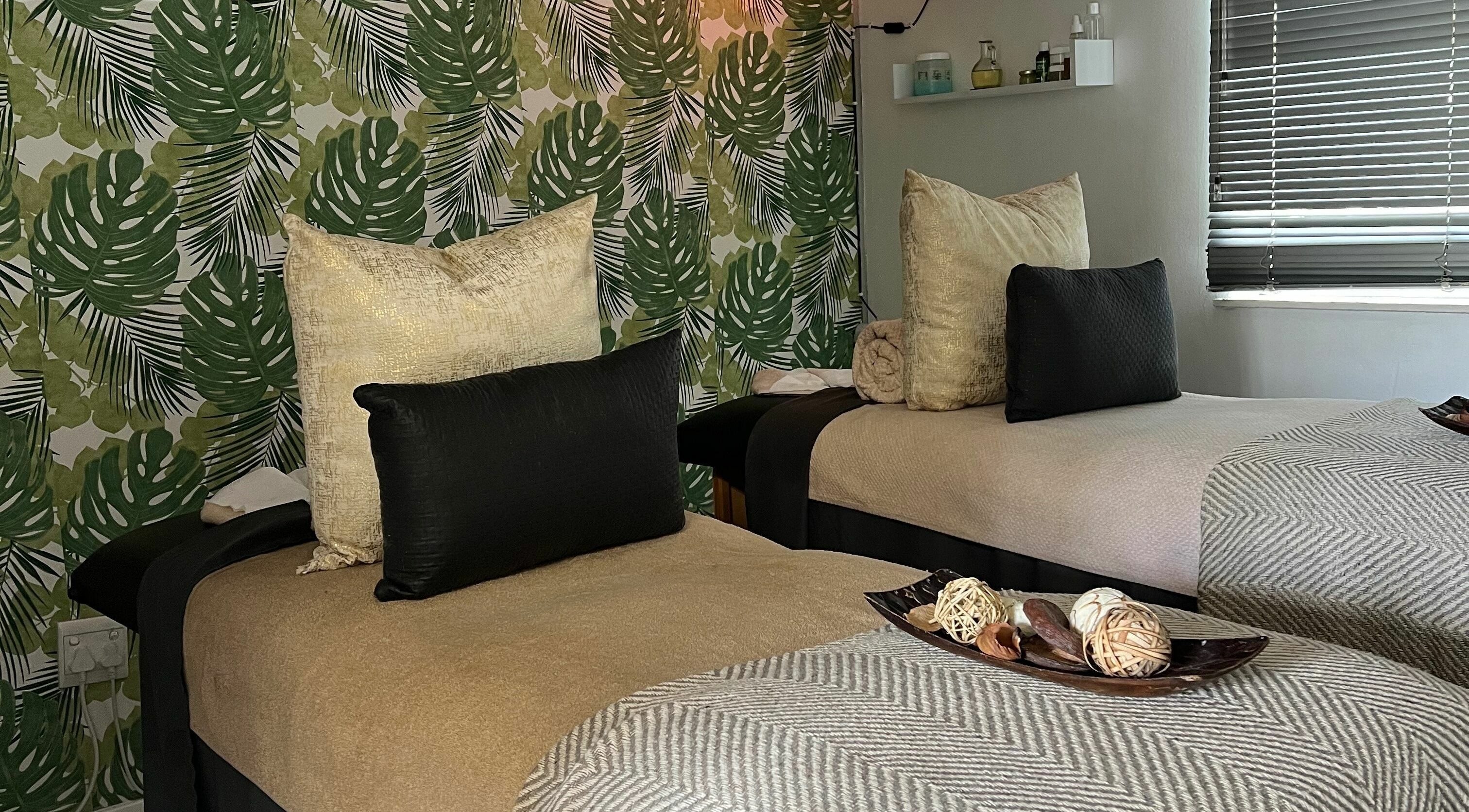 Relaxing therapy room with two beds at Snes Wellness Space, Sandton, Gauteng, ZA. Green leafy decor.