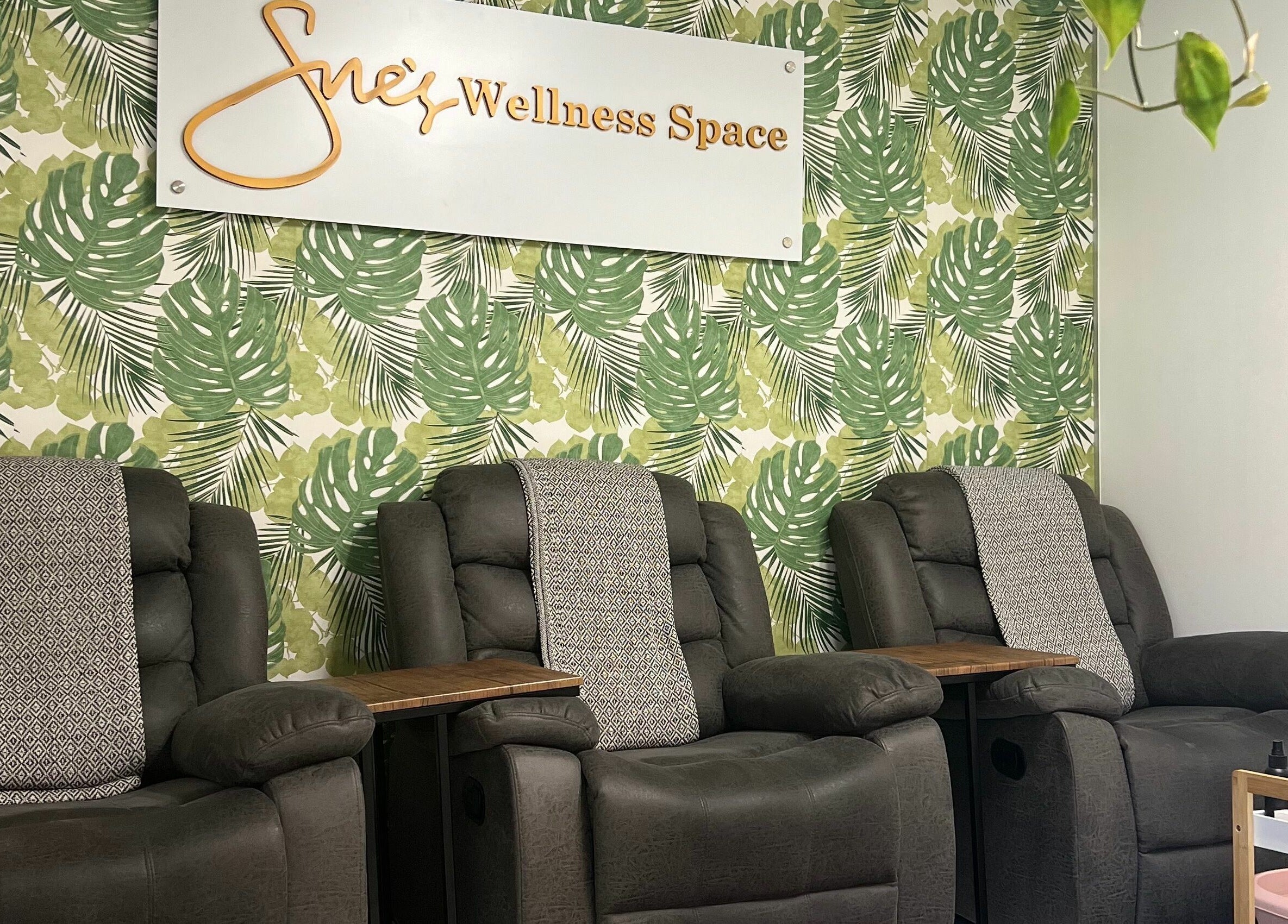 Relaxation chairs at Snes Wellness Space in Sandton, Gauteng, ZA with tropical leaf wallpaper.