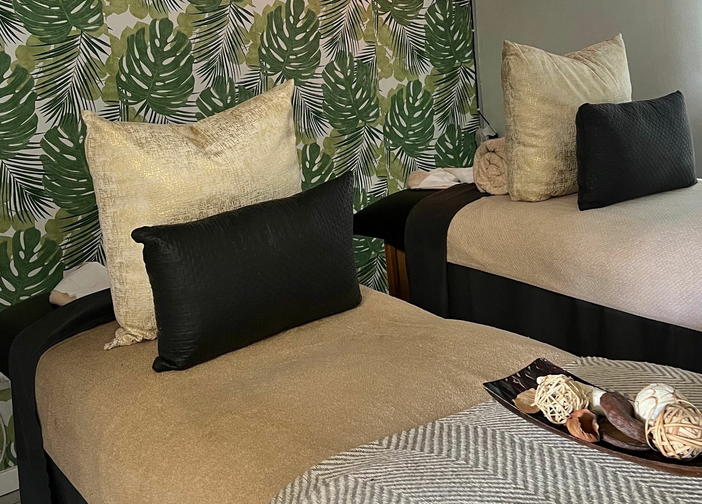 Luxurious treatment beds at Snes Wellness Space, Sandton, Gauteng, ZA with tropical decor and plush cushions.