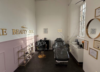Elegant interior of The Beauty Geek UK in Paisley, Scotland, GB showcasing stylish treatment chairs and decor.