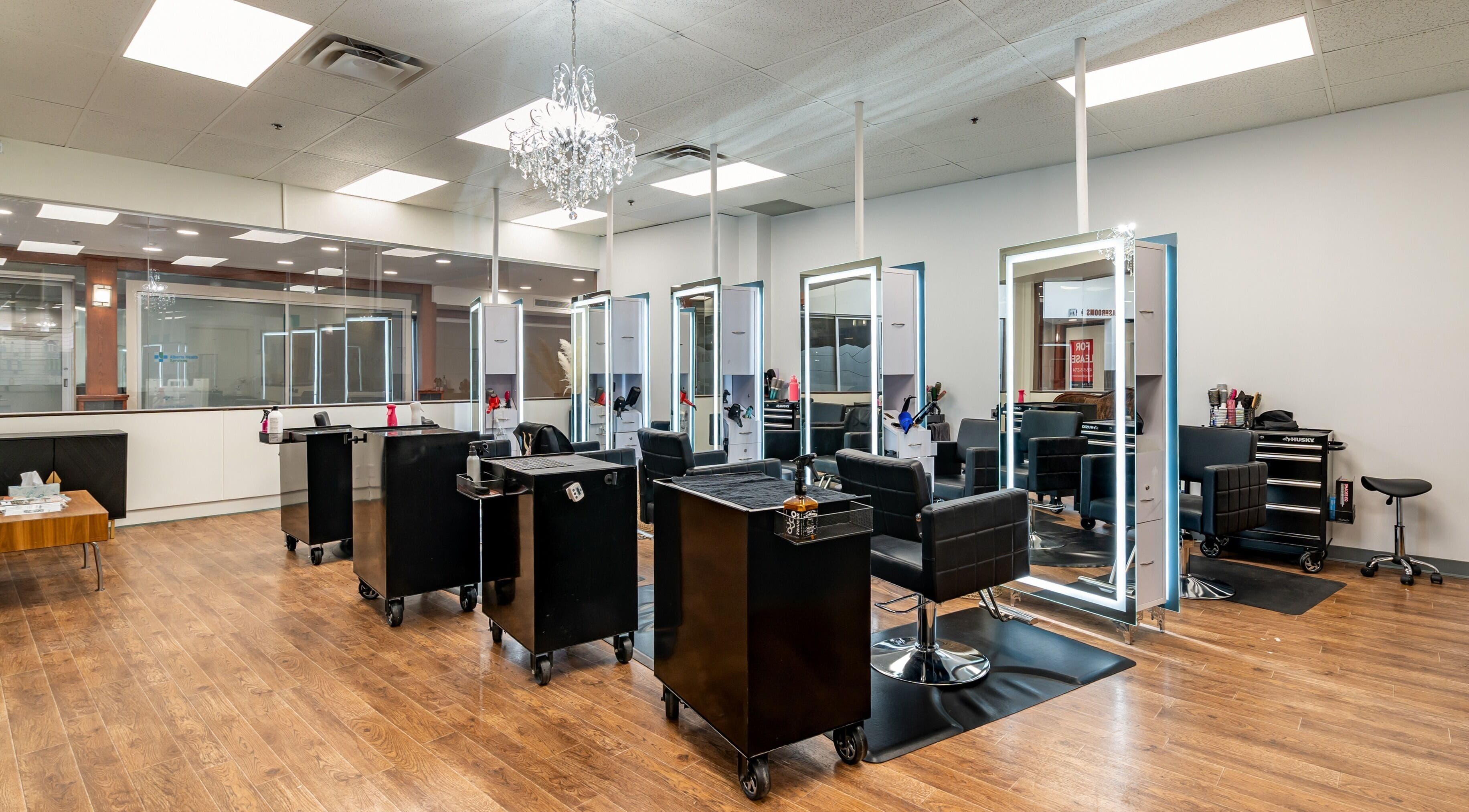 Modern salon setup at Angles Hair and Esthetics in Calgary, Alberta, CA with stylish black chairs and mirrors.
