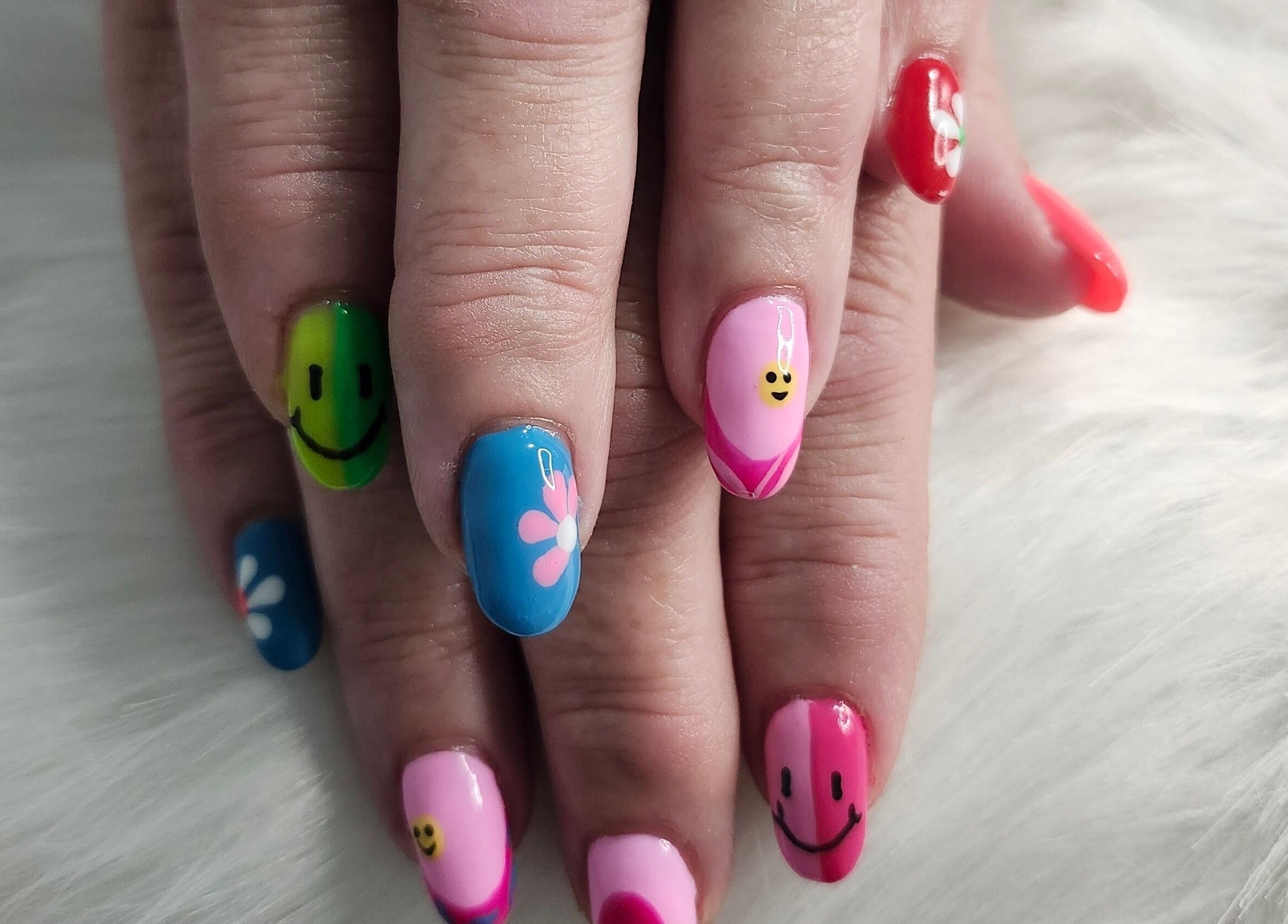 Colorful nail art with smiley faces at Opulence Nails, Middle Sackville, Nova Scotia, CA.