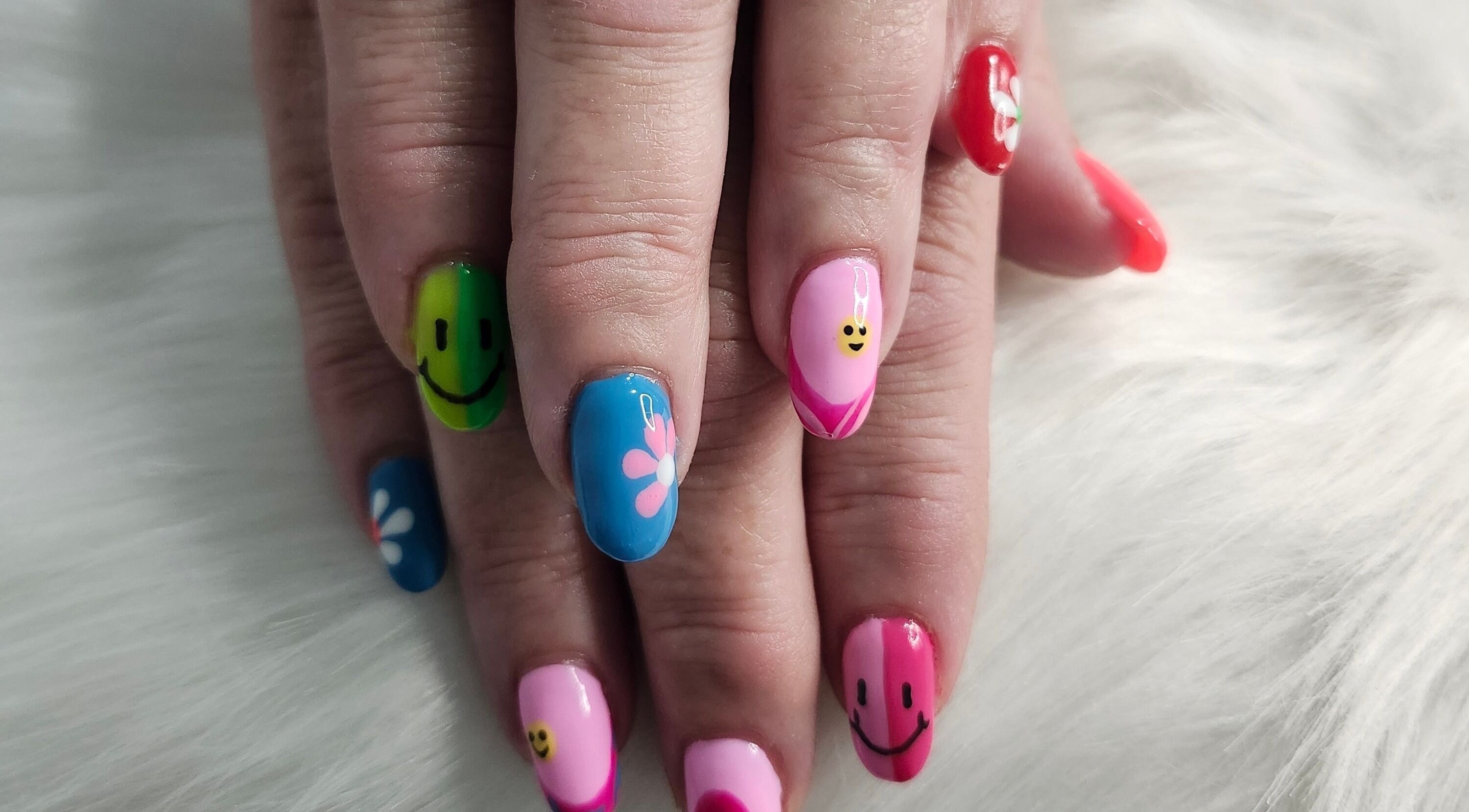 Colorful nail art with smiley faces at Opulence Nails, Middle Sackville, Nova Scotia, CA.