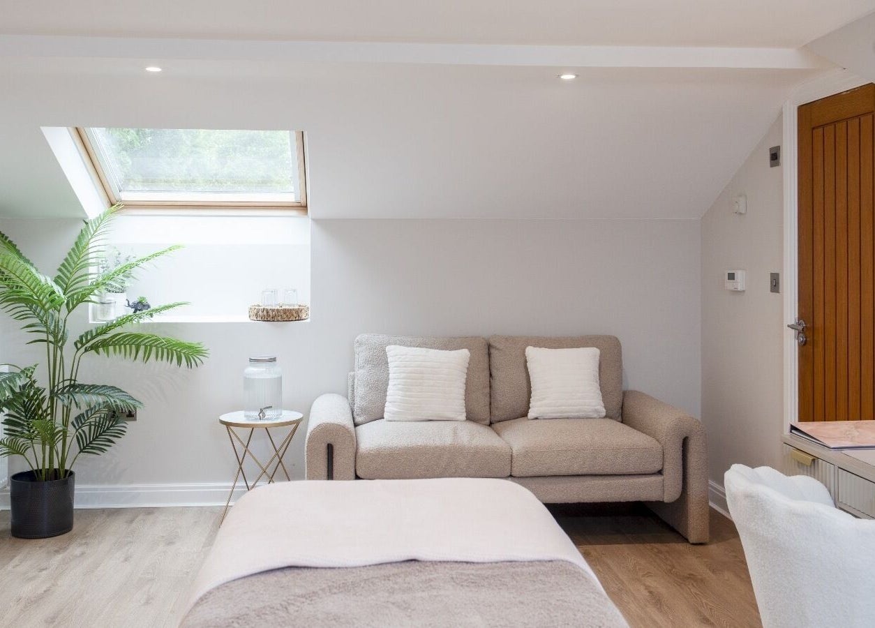 Cozy wellness room at Skin Serenity, Bishopthorpe, England, GB with sofa, plants, and soft lighting.