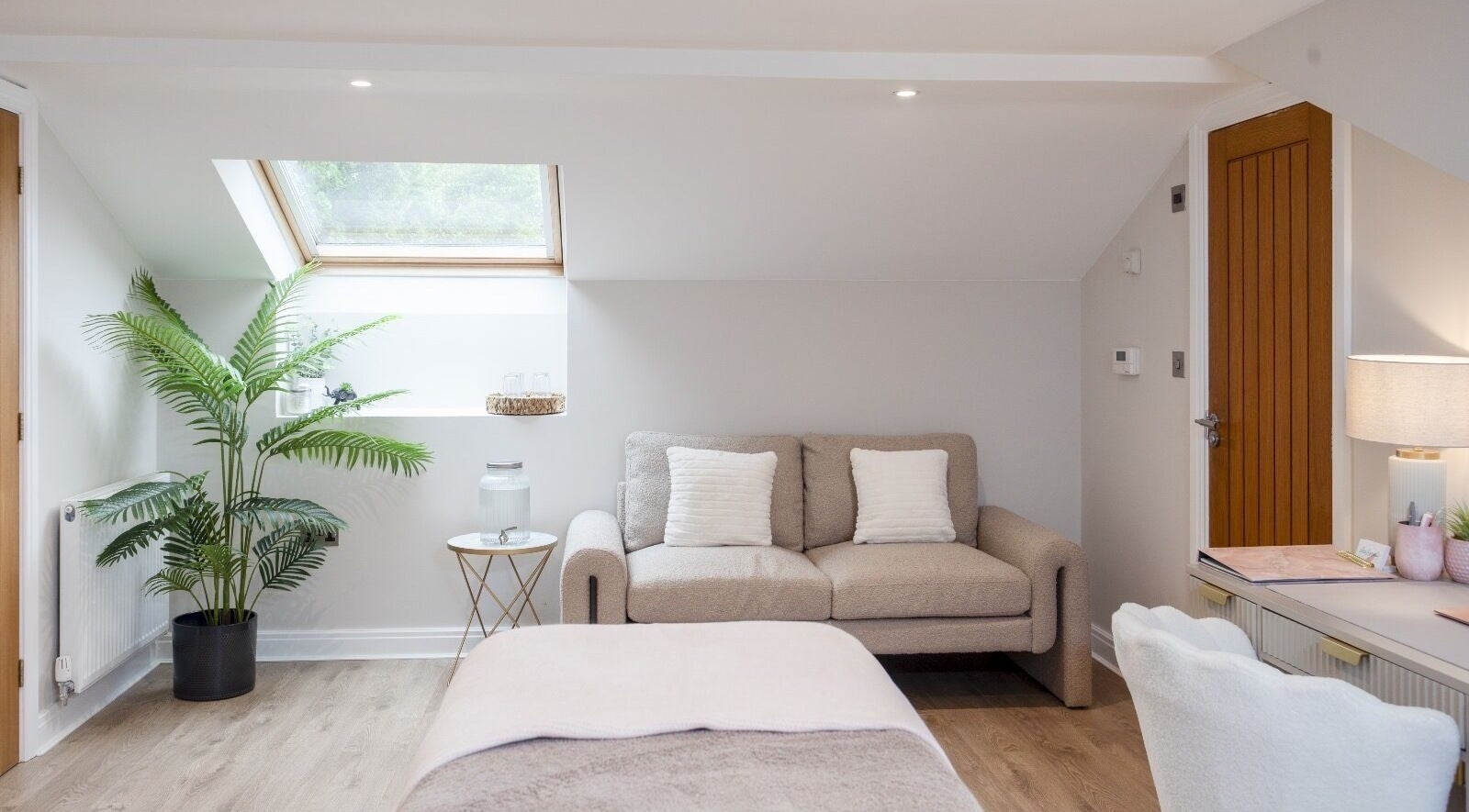 Cozy wellness room at Skin Serenity, Bishopthorpe, England, GB with sofa, plants, and soft lighting.
