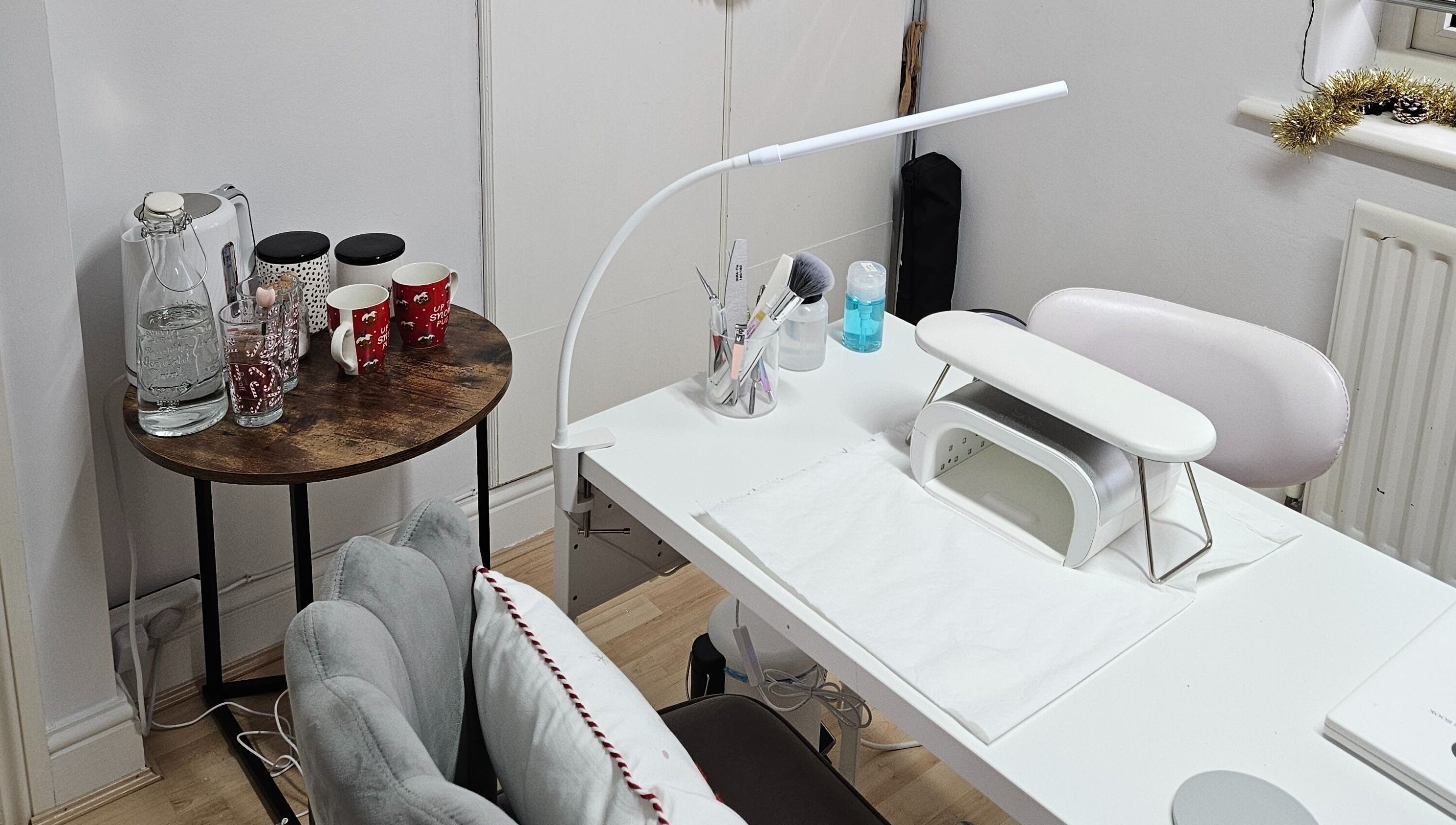 Nail treatment station at Nails by Verity, Tenterden, England, GB featuring a neat setup with beverages.