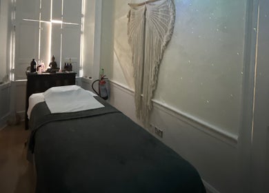Cozy massage room at Touch Holistic Therapy, Edinburgh, Scotland, GB, featuring soft lighting and calm decor.