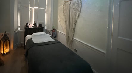 Cozy massage room at Touch Holistic Therapy, Edinburgh, Scotland, GB, featuring soft lighting and calm decor.