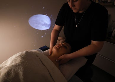 Relaxing neck massage at Touch Holistic Therapy, Edinburgh, Scotland, GB in a serene, dimly lit room.