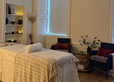 Relaxing therapy room at Touch Holistic Therapy, Edinburgh, Scotland, GB with massage bed and cozy decor.