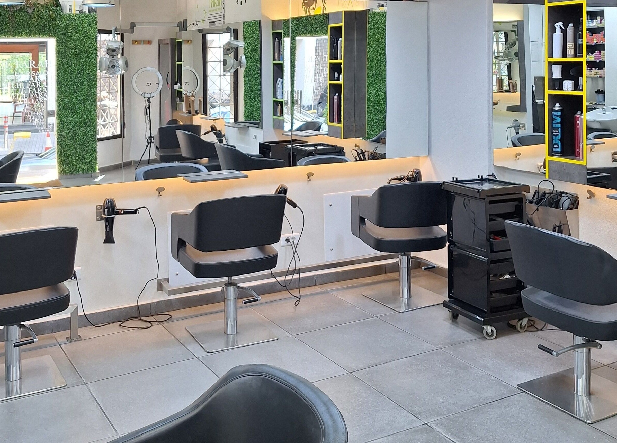 Modern interior of Elie Farah Salon in Jal El Dib, Mount Lebanon Governorate, LB with sleek styling stations.