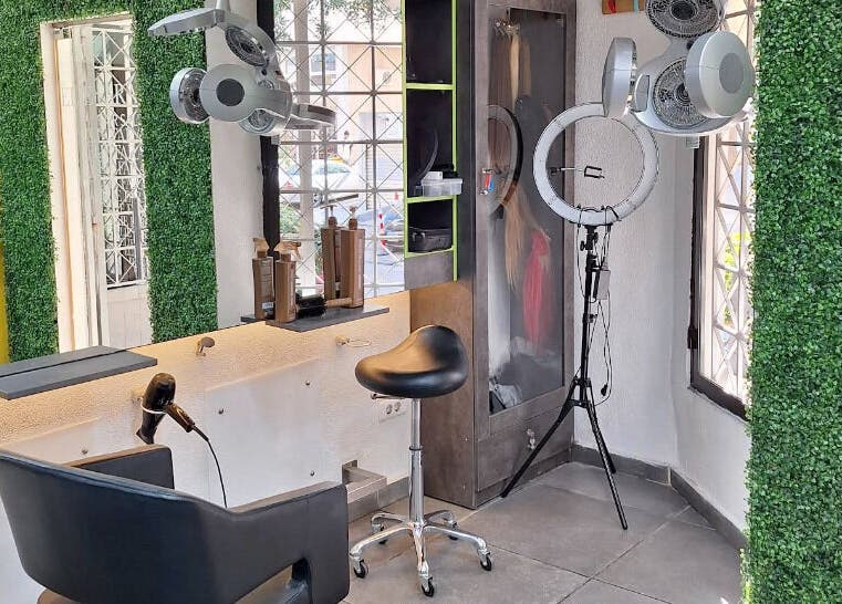 Inside Elie Farah Salon in Jal El Dib, Mount Lebanon Governorate, LB showcasing sleek styling stations and greenery.