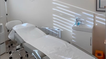 Treatment room at Katie Mai Beauty & Aesthetics, Stevenage, England, GB with a white therapy bed and sink.