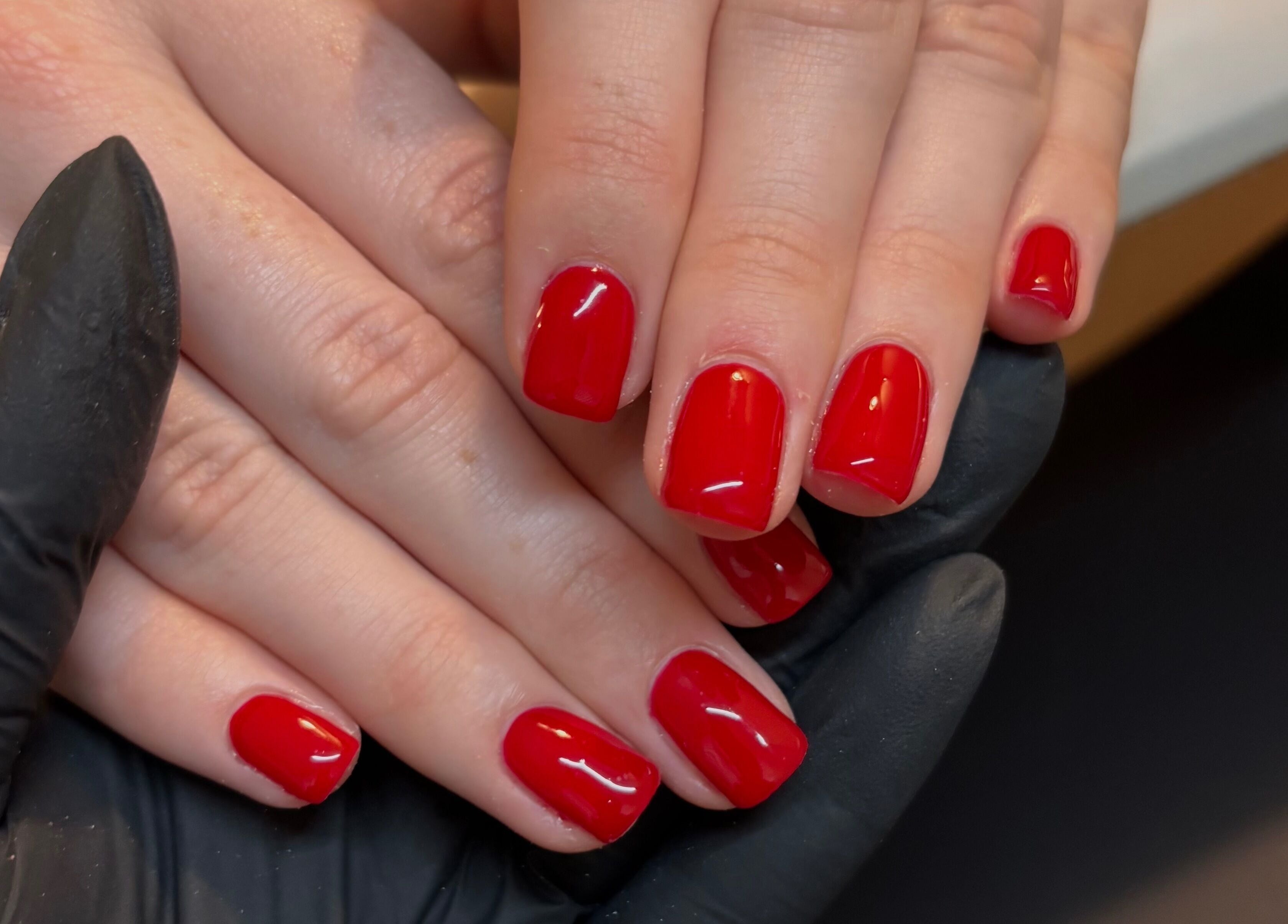 Vibrant red manicure at Katie Mai Beauty & Aesthetics, Stevenage, England, GB. Professional nail services.
