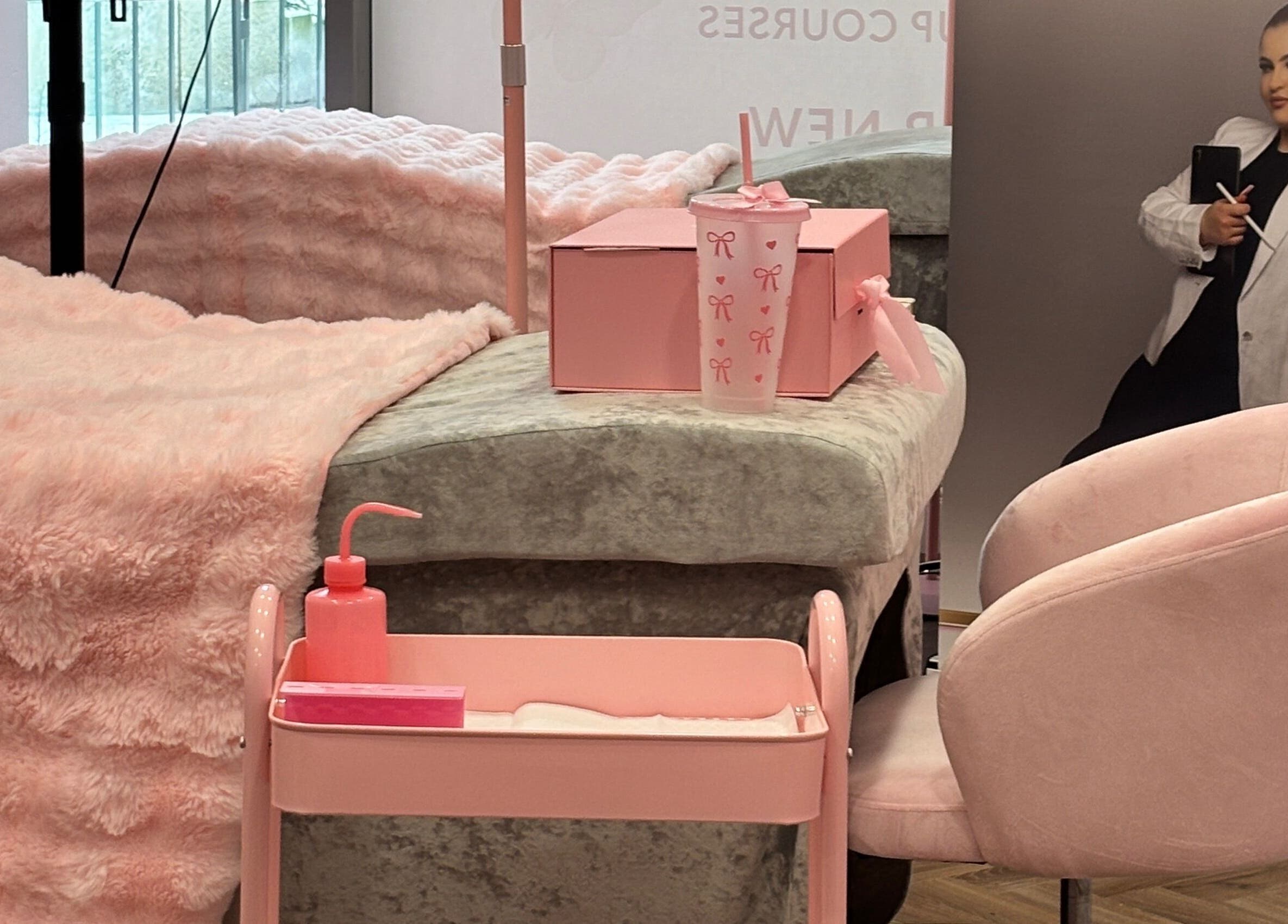 Cozy treatment room at FK Baddies in Dublin, County Dublin, IE, featuring soft pink decor and plush seating.