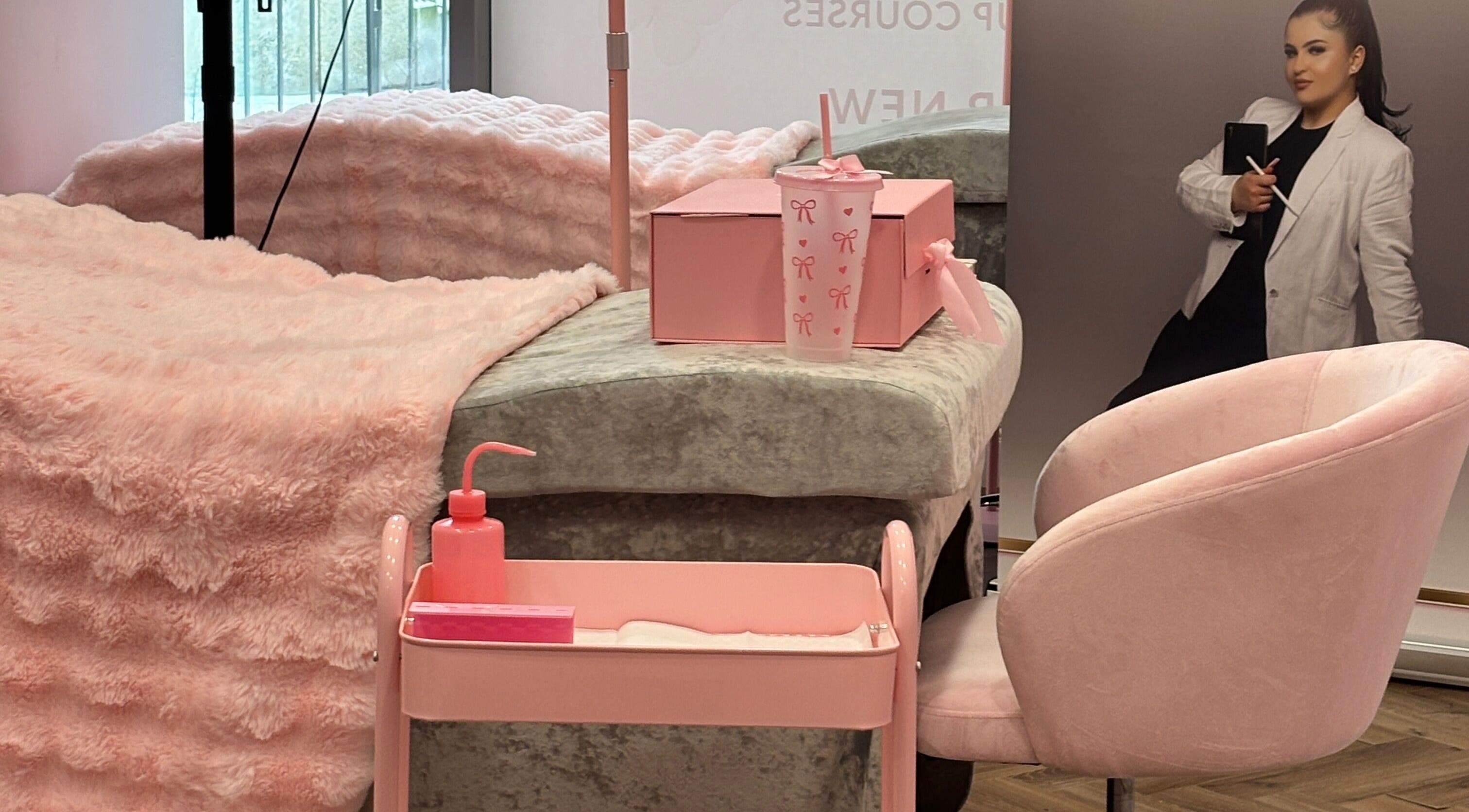 Cozy treatment room at FK Baddies in Dublin, County Dublin, IE, featuring soft pink decor and plush seating.