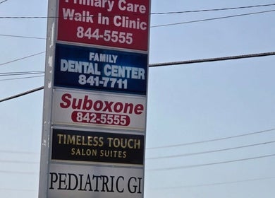 Directory sign near Kimberly's Chair, New Port Richey, Florida, US displaying local businesses.