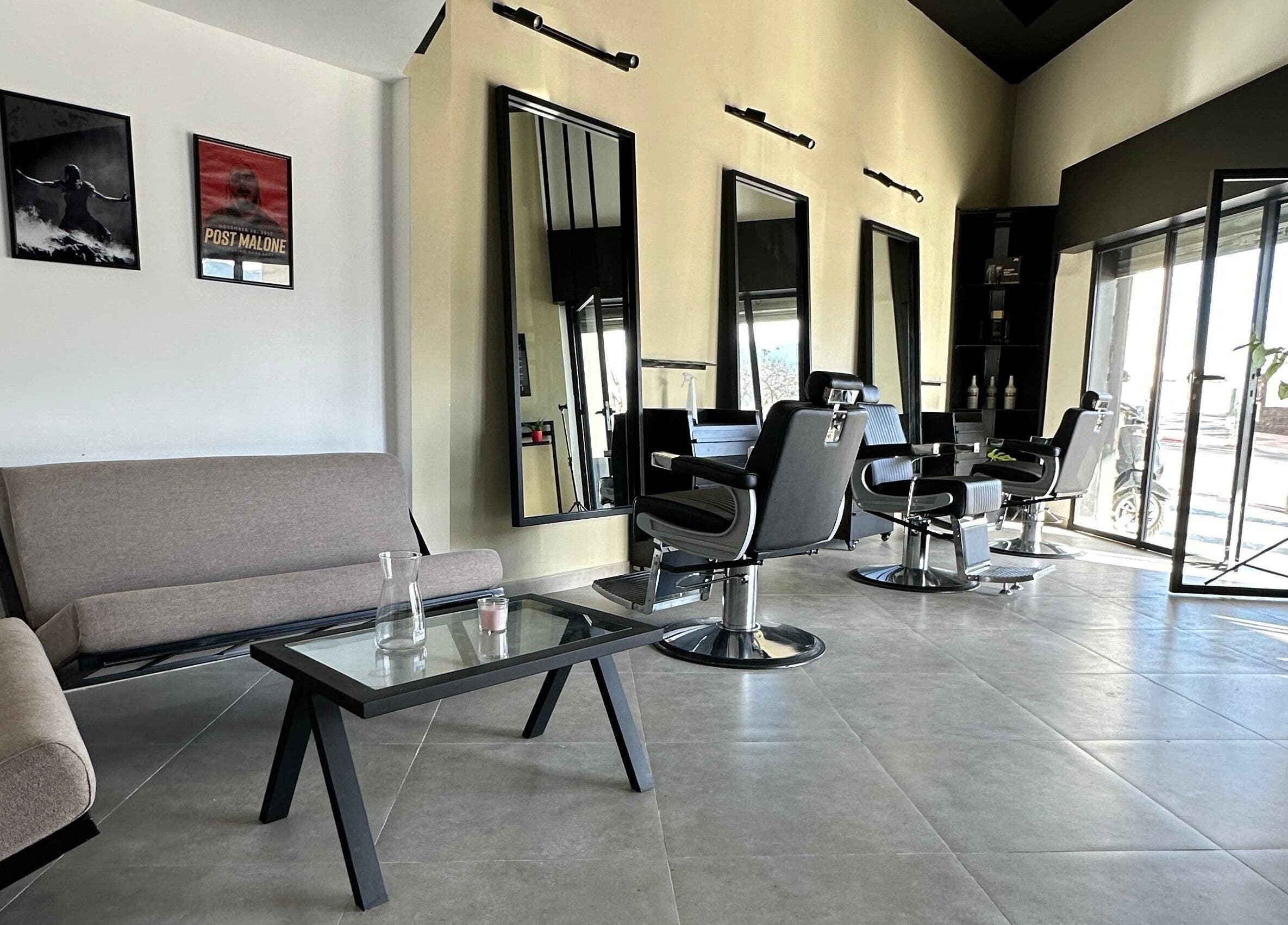 Modern interior of Soufian Allal in Tetouan, Tangier-tétouan-al Hoceima, MA featuring sleek barber chairs.