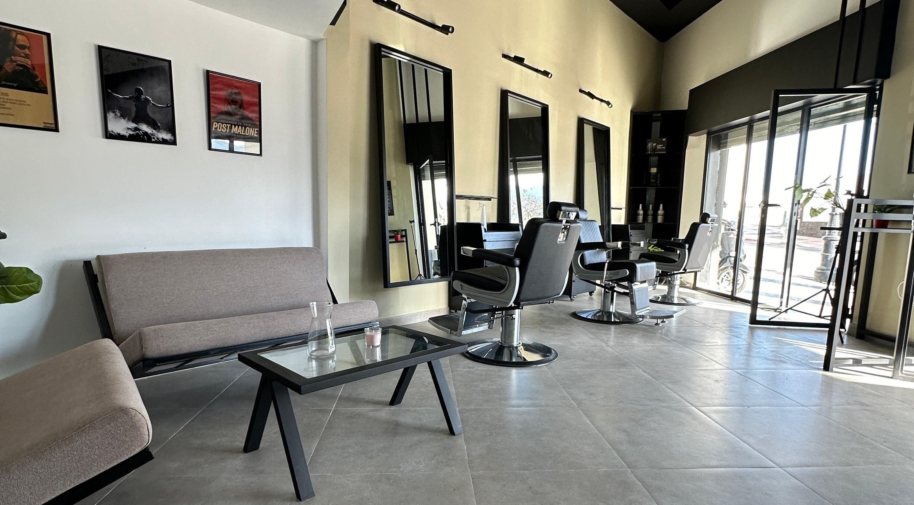 Modern interior of Soufian Allal in Tetouan, Tangier-tétouan-al Hoceima, MA featuring sleek barber chairs.