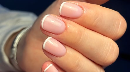 Close-up of a French manicure at MCR Beauty Room, Worsley, England, GB showcasing neat pink polish and white tips.