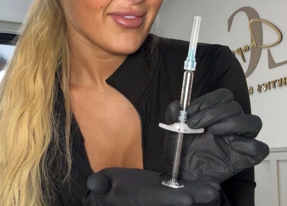 Aesthetician with syringe at Liv Chapman Aesthetics & Nails, Watford, England, GB, offering beauty treatments.