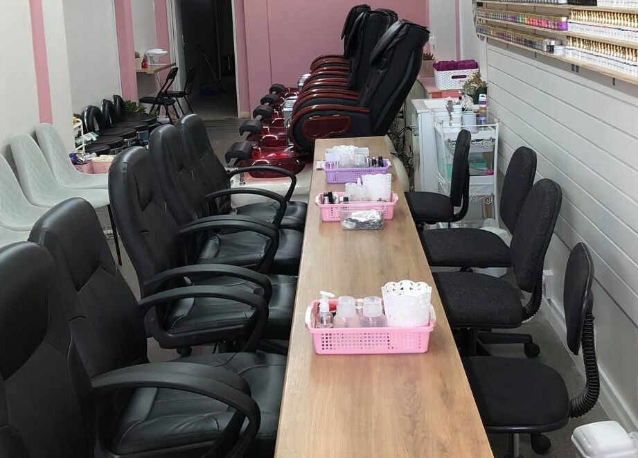 Inside view of Ruby Nails, Palmerston North, featuring comfy chairs and nail service stations.