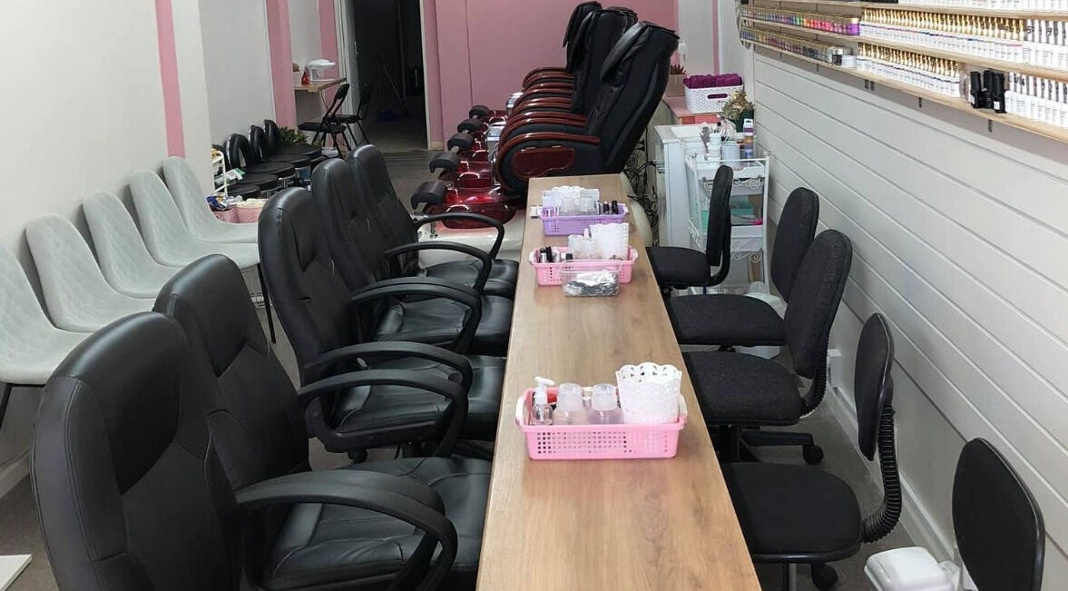 Inside view of Ruby Nails, Palmerston North, featuring comfy chairs and nail service stations.
